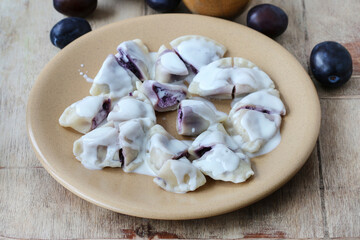 Sweet dumplings with purple fruits and cottage cheese.