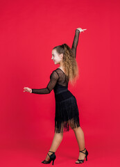 child girl elegant ballroom dancer wear black dress in dance pose, professional dancer