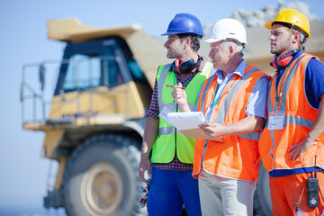 Worker standing by machinery on site