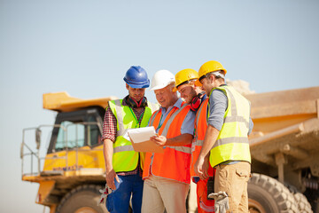 Worker standing by machinery on site