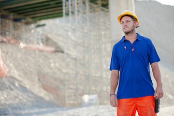 Workers and machinery in quarry