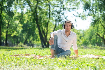 Man in the park listens to music