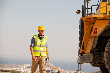 Businessmen in hard hats standing on site