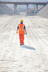 Worker reading blueprints on site