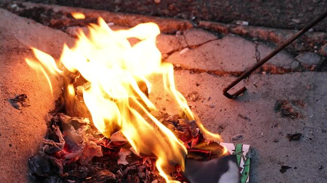 Chinese hungry ghost festival burning flame fire glowing ashes firefly colourful variety prayer paper joss money fake currency joss stick mini fag food fruit