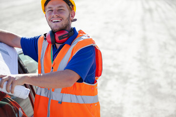 Worker walking by machinery on site