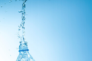 Drinking water in a bottle that splashes and is clean, bright, natural.