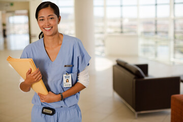 Portrait of smiling nurse in hospital corridor