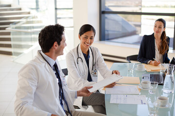 Doctors and businesswoman talking in meeting