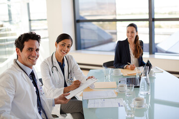 Doctors and businesswoman talking in meeting