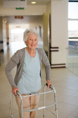 Senior patient using walker in hospital