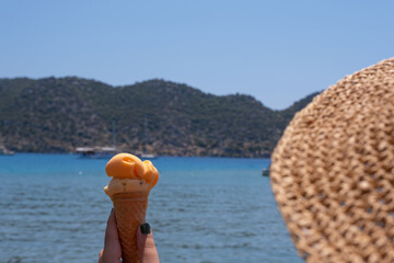 woman eating ice cream by the sea.