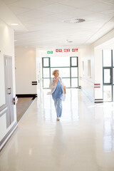 Fototapeta na wymiar Doctor rushing down hospital corridor