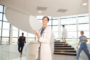 Portrait of smiling doctor in hospital atrium