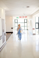 Doctor rushing down hospital corridor