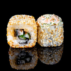 Pair of sushi on black background with reflection