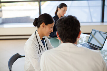 Fototapeta premium Doctors and businesswoman talking in meeting