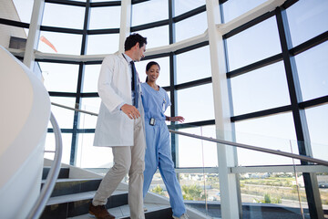 Doctor and nurse talking on staircase