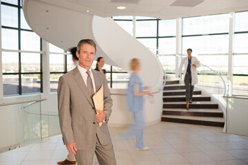 Portrait of smiling businessman in hospital