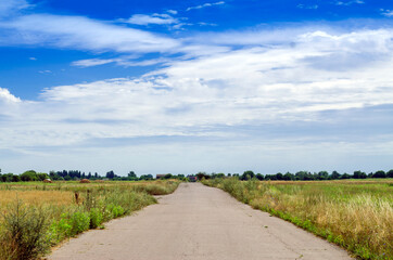 road in the countryside with blue sky on the horizon