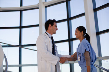 Obraz premium Doctor and nurse handshaking on hospital staircase