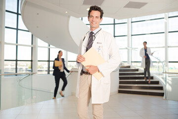 Portrait of smiling doctor in hospital atrium