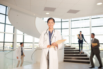 Portrait of smiling doctor in hospital atrium