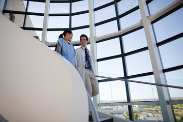 Doctor and nurse talking on staircase