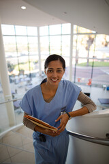 Portrait of smiling nurse on hospital staircase