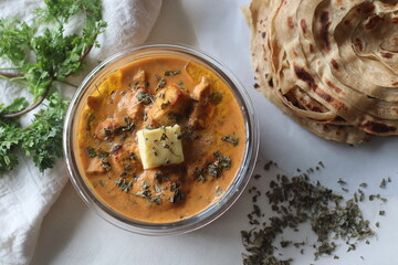 Butter chicken made of grilled chicken chunks cooked in buttery creamy tomato gravy served with...