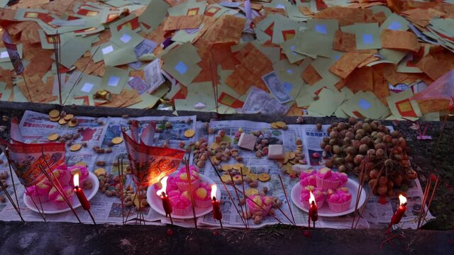 hinese hungry ghost festival burning flame fire glowing ashes firefly colourful variety prayer paper joss money fake currency joss stick mini fag food fruit offering