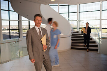 Portrait of smiling businessman in hospital