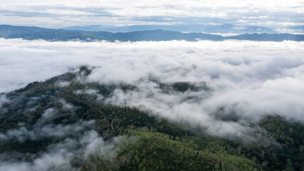 aerial view of clouds on beautiful mountains beautiful nature that covers the fertile tropical forests of Nan Province Northern Thailand, Ya Luang Suan