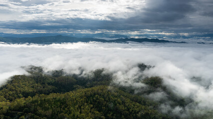aerial view of clouds on beautiful mountains beautiful nature that covers the fertile tropical forests of Nan Province Northern Thailand, Ya Luang Suan