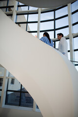 Doctor and nurse talking on staircase