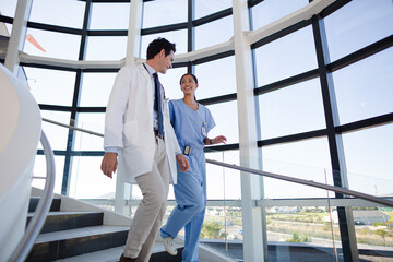Doctor and nurse talking on staircase