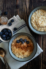 Oatmeal or porridge, for breakfast. Wooden background