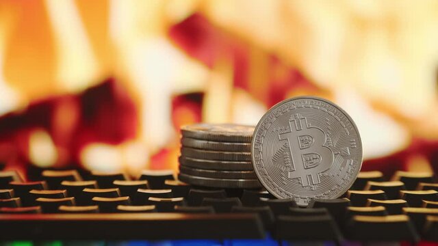 Bitcoin cryptocurrency on blurred background of fire. Virtual money. Fall and rise of cryptocurrency. High quality 4k footage