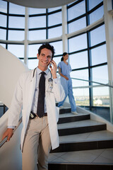 Doctor talking on cell phone in hospital