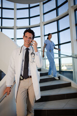 Doctor talking on cell phone in hospital