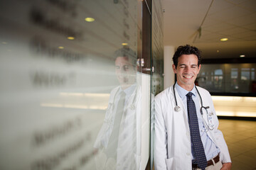 Portrait of smiling doctor in hospital corridor