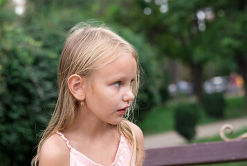 portrait of a child in profile, girl, blonde, 7 years old, surprised face