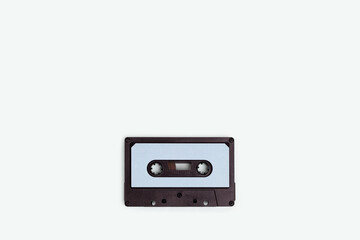 Obraz premium Cassette tape on a blue pastel background. Minimalistic composition with copyspace.