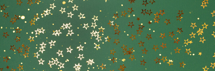 Banner with trendy gold stars confetti on a green background.