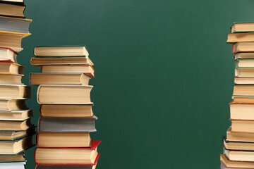 Many hardcover books near green chalkboard, space for text. Library material