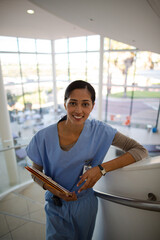 Portrait of smiling nurse on hospital staircase
