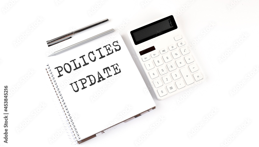 Poster notepad with text policies update with calculator and pen. white background. business concept