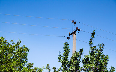 Electric support pole against blue sky background