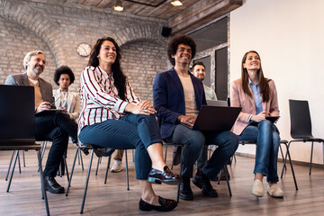 Group of diverse business people in conference meeting room during presentation.