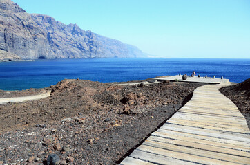 TENERIFE, SPAIN: Scenic seashore view of Los Gigantes ancient rocks with blue sea waters